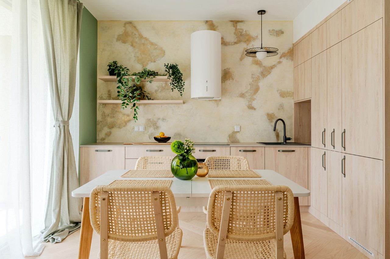 A modern kitchen with wood, plants and stylish accessories.