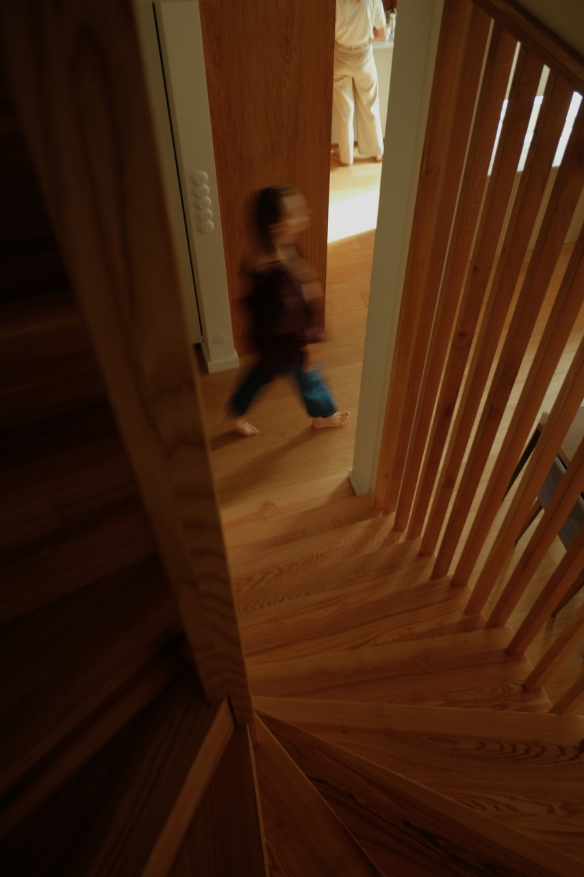 Drewniane schody z eleganckim balustradą i domowym tłem.