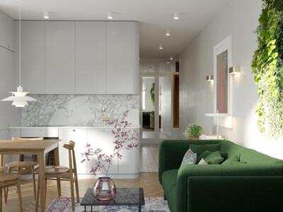 Przytulny salon z zieloną kanapą i nowoczesną kuchnią.