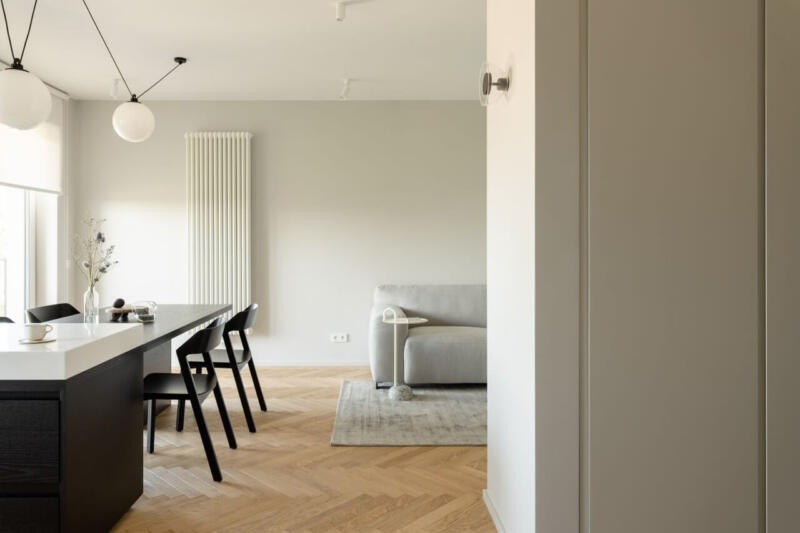 Elegancki salon z jadalnią, minimalistyczny wystrój i designerskie lampy.