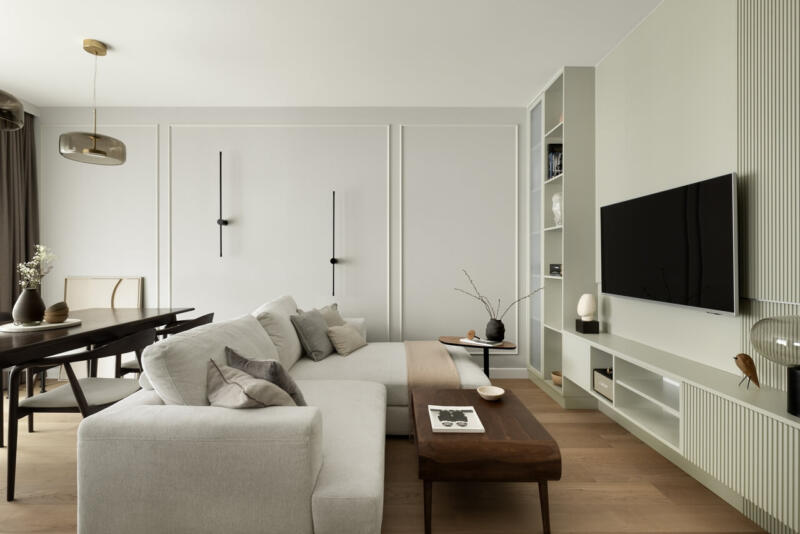 Minimalistyczny salon z eleganckimi meblami i subtelnymi dodatkami.