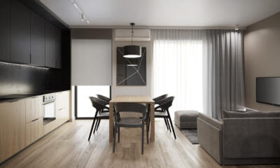 Nowoczesny salon z kuchnią, szare meble i minimalistyczny design.