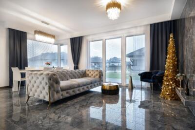 Nowoczesny salon z elegancką sofą i złotym detalem. Magia wnętrz!