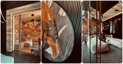 1. Sauna z ceglaną ścianą i drewnianym wykończeniem.2. Designerski wzór z tygrysim motywem na ścianie.3. Elegancki salon z nowoczesnym wystrojem i rzeźbą buddy.