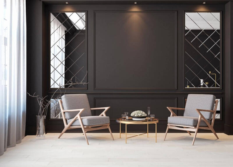 Elegancki salon z designerskimi fotelami i nowoczesnym stolikiem.