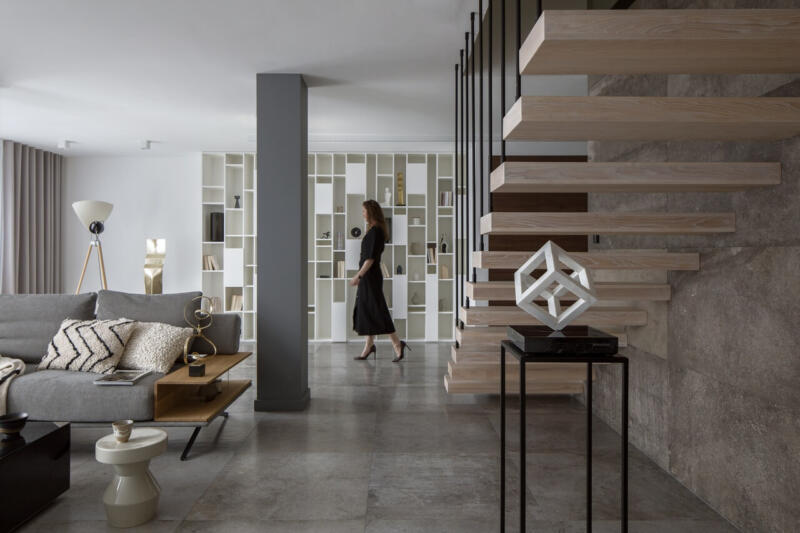Nowoczesne wnętrze z designerskimi schodami i eleganckimi półkami.