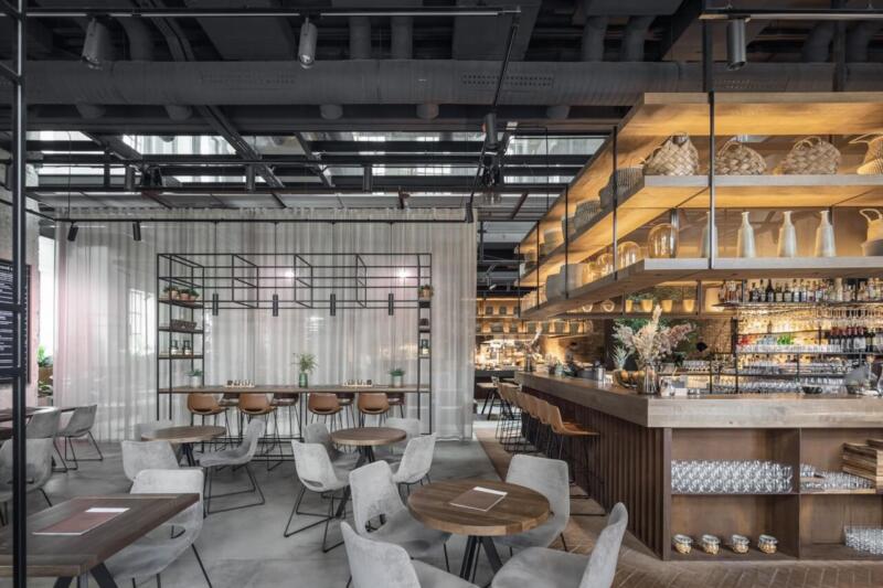 Nowoczesna restauracja z eleganckim wystrojem i nastrojowym oświetleniem.