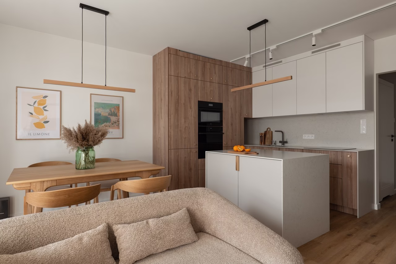 A modern kitchen with wooden accents and a minimalist table.