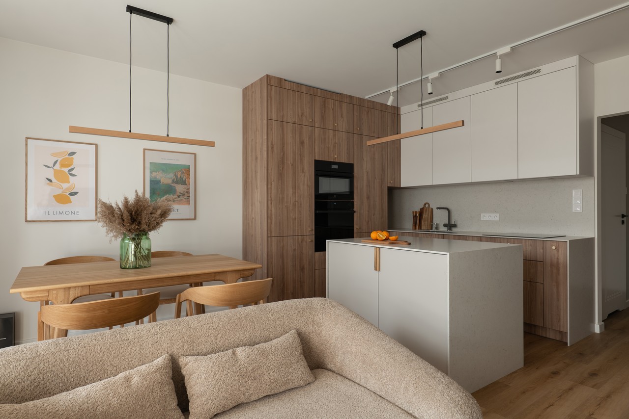 A modern kitchen with wooden accents and a minimalist table.