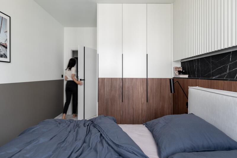 Bedroom with elegant wardrobe, modern wood and white.