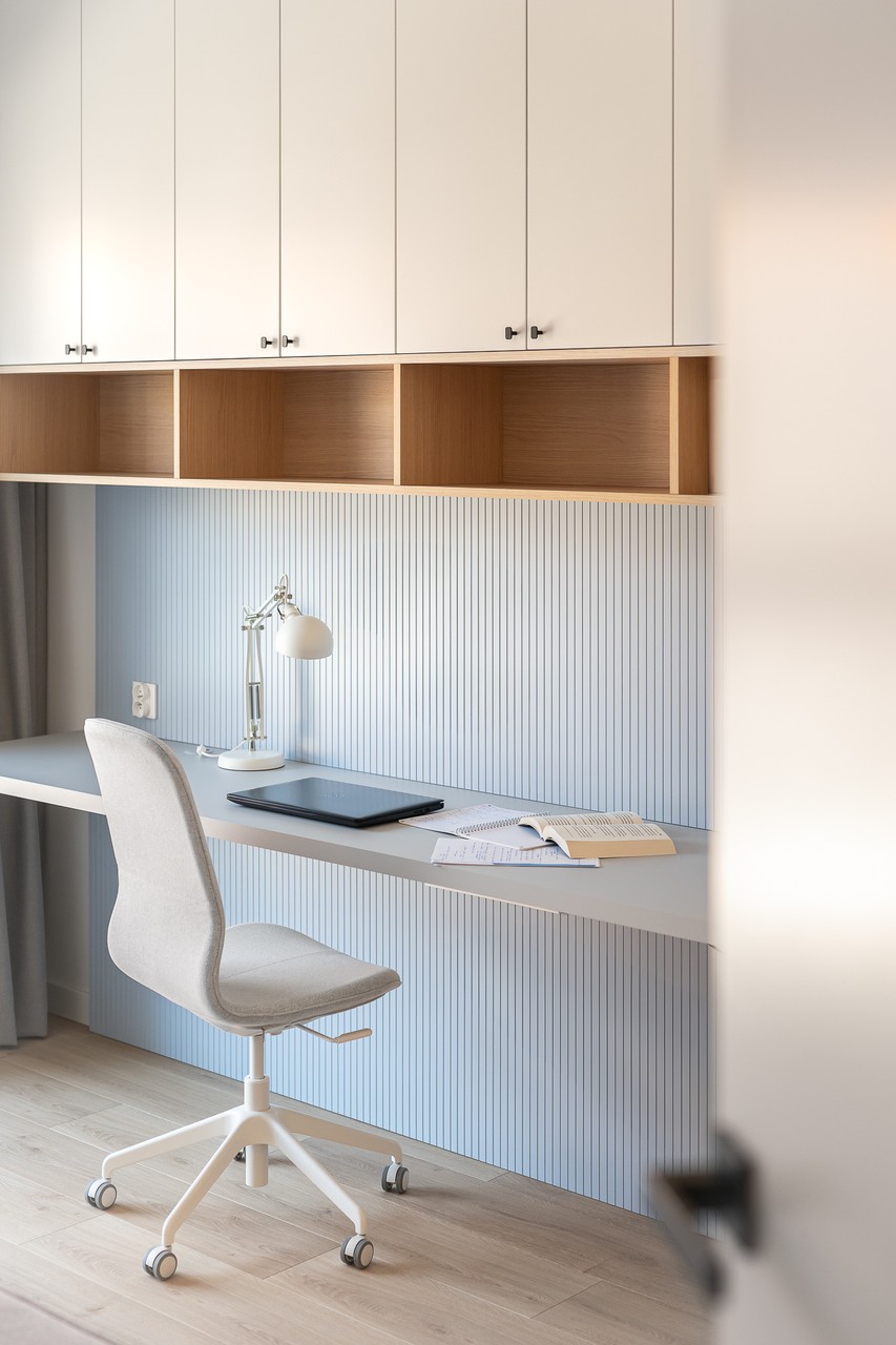 Desk with designer chair and lamp in a contemporary interior.