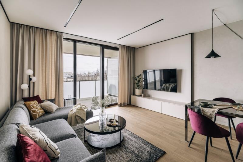 Modern living room with grey furniture and views of the terrace.