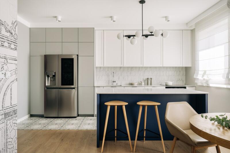 Modern kitchen with white cabinets and sleek bar stools.