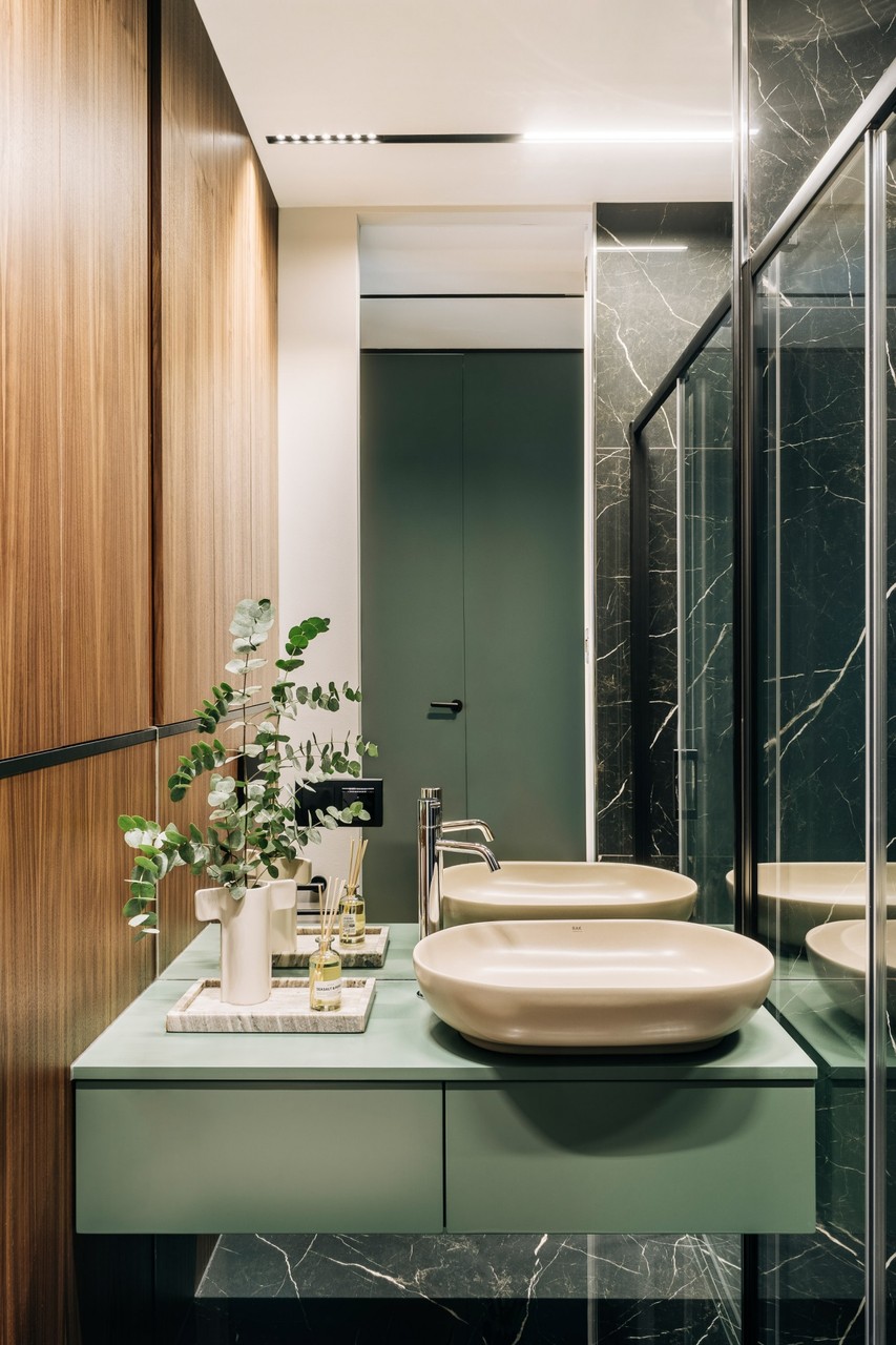 Elegant bathroom with green countertop and wooden accents.