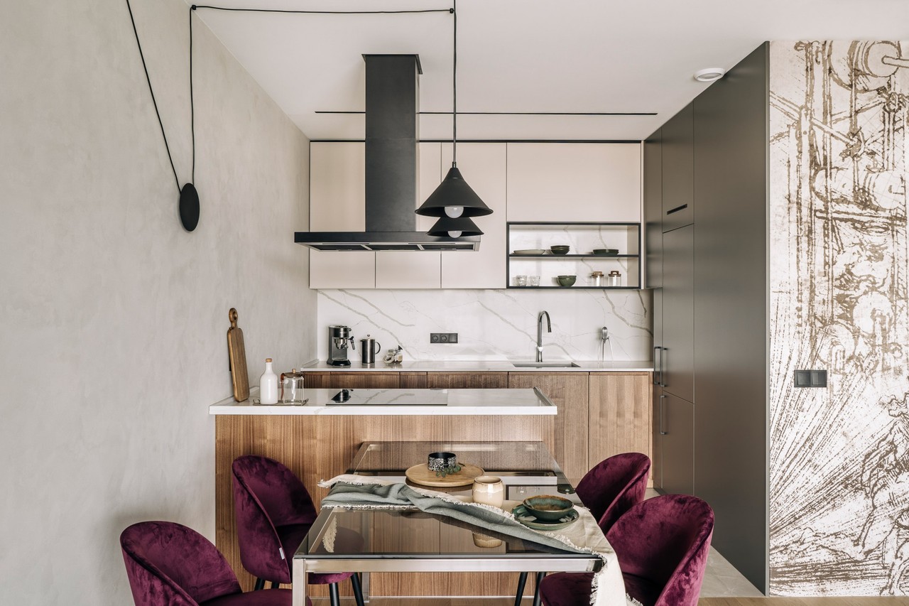 Modern kitchen with burgundy chairs and marble accents.