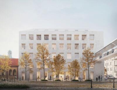 Nowoczesny budynek z jasną fasadą, otoczony złotą jesienną roślinnością, minimalistyczny design.