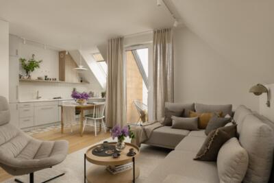Przestronny salon z jasnym, eleganckim wystrojem i nowoczesną kuchnią.