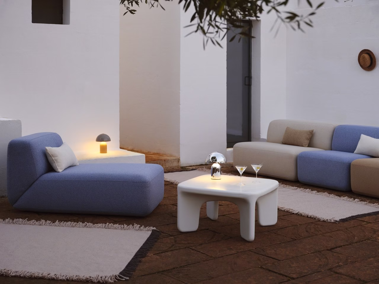 Stylowe patio z nowoczesnymi meblami i nastrojowym oświetleniem.