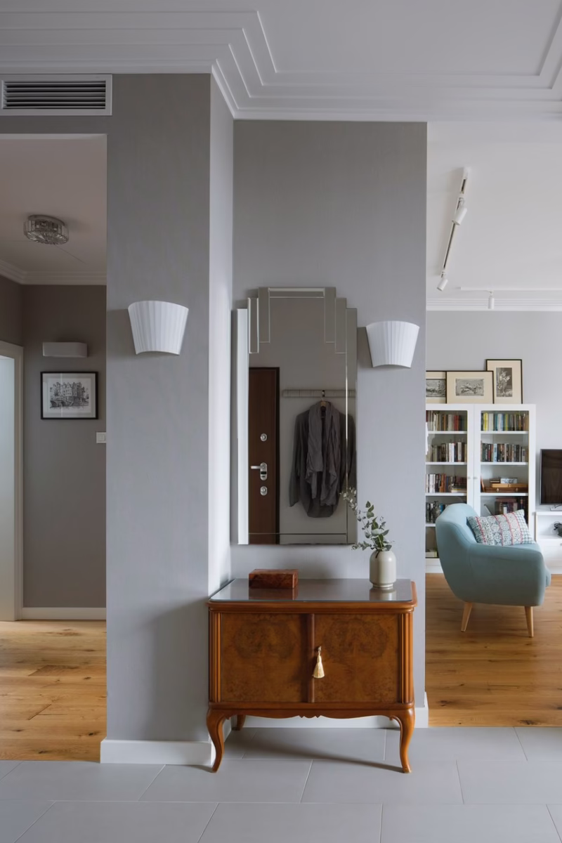 Stylish hallway with mirror and dresser in an elegant interior.