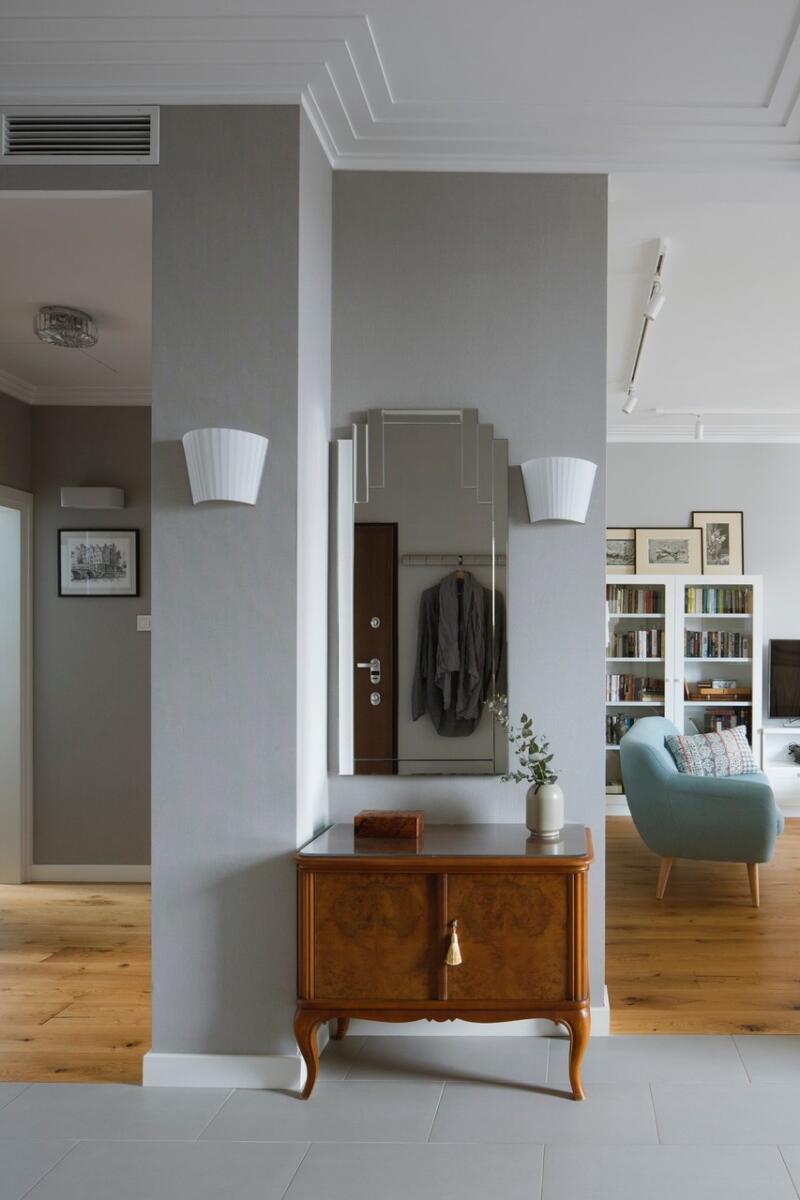 Stylish hallway with mirror and dresser in an elegant interior.