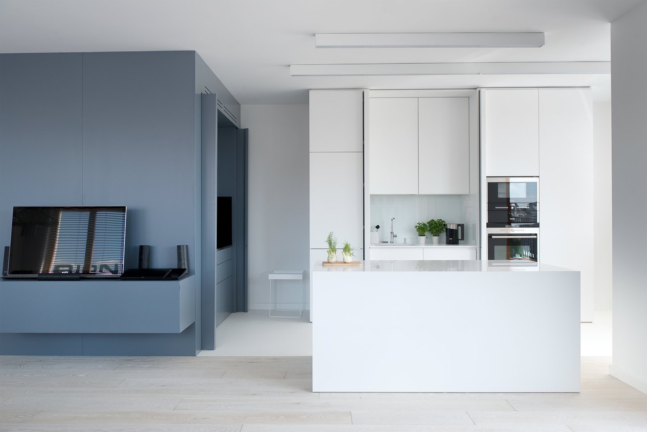 Modern kitchen with white island and grey accents.