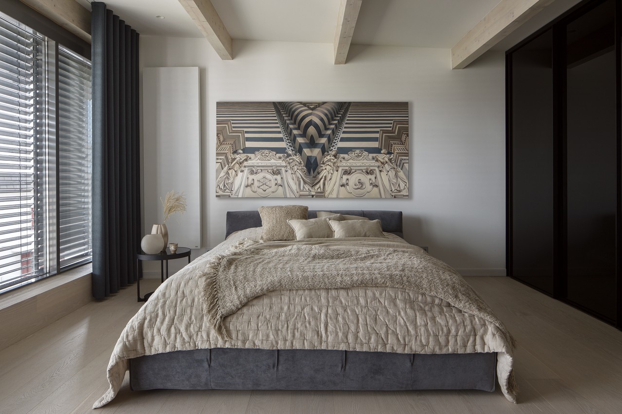 A modern bedroom with elegant imagery and designer furniture.