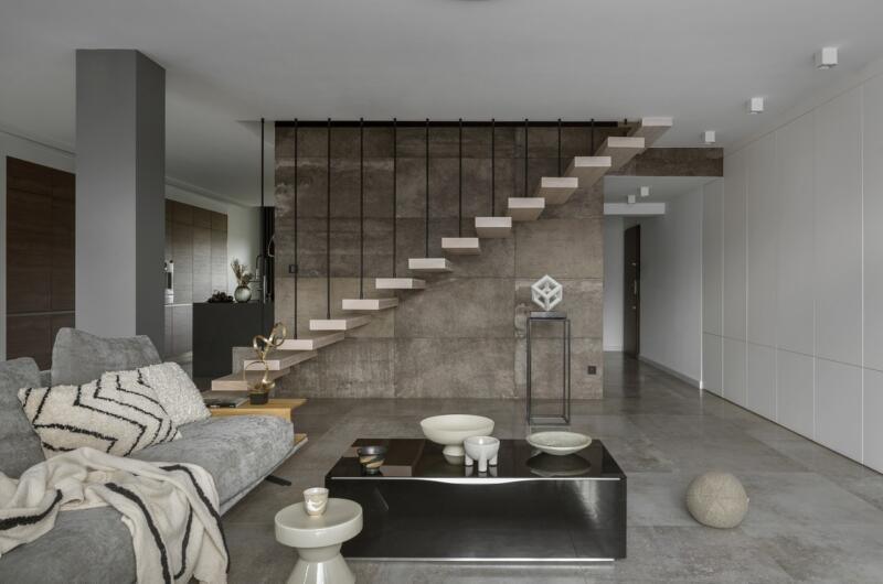 Modern interior with designer staircase and elegant accessories.