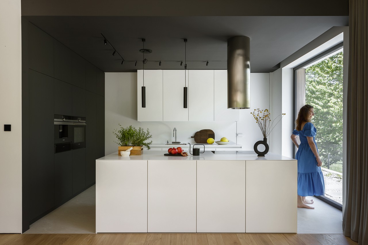 Modern kitchen with large window and elegant accessories.