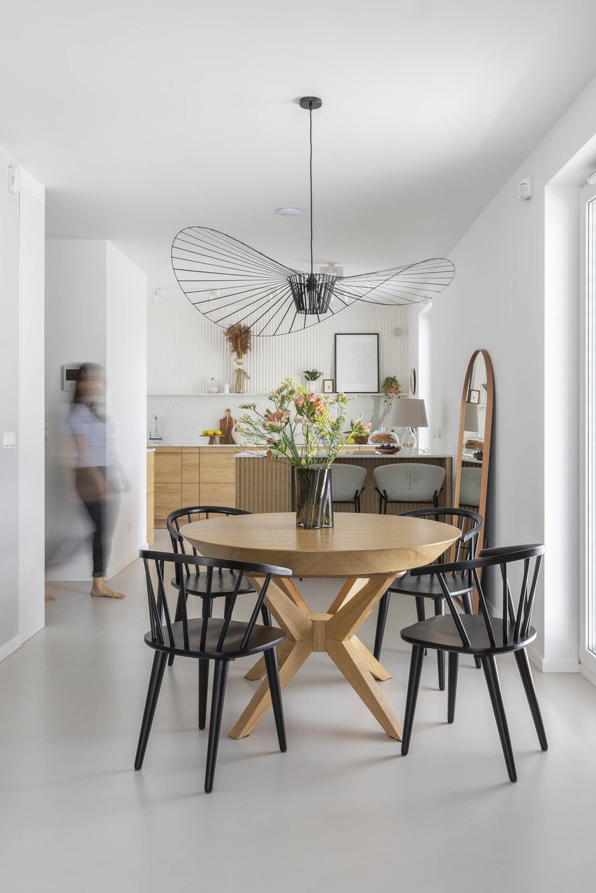 Modern dining room with designer chandelier and round table.