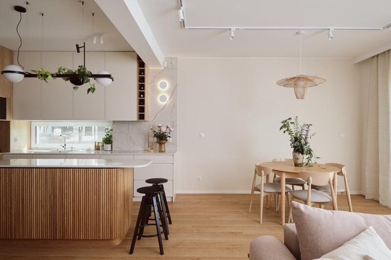 Elegant kitchen with wooden island and stylish dining room.Elegant kitchen with wooden island and stylish dining room.