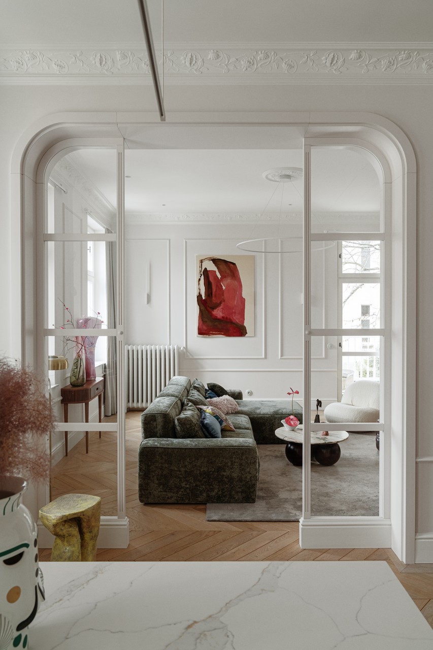 Nowoczesny salon z designerską sofą i sztuką na ścianie.