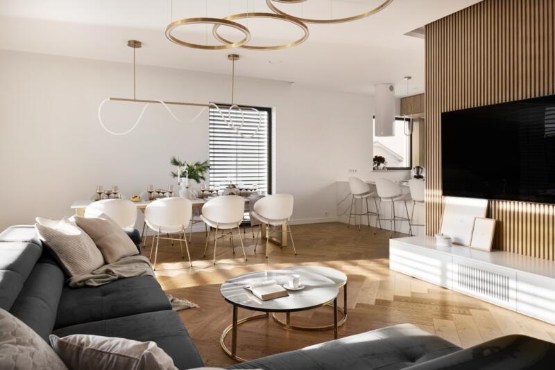 Modern living room with elegant furniture and gold accents.