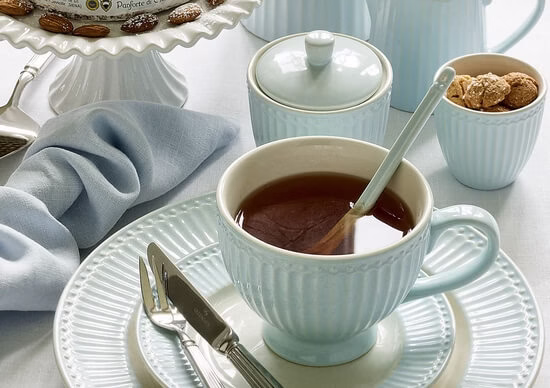 Elegancka zastawa stołowa w odcieniach pastelowego błękitu.