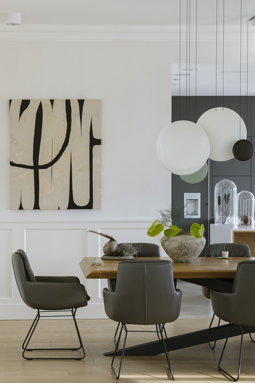 Modern dining room with designer chairs and art on the wall.