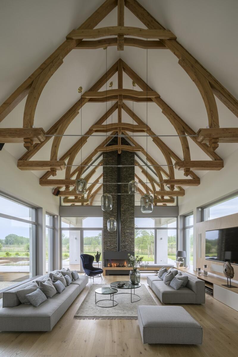 Elegant living room with wooden beams and fireplace.