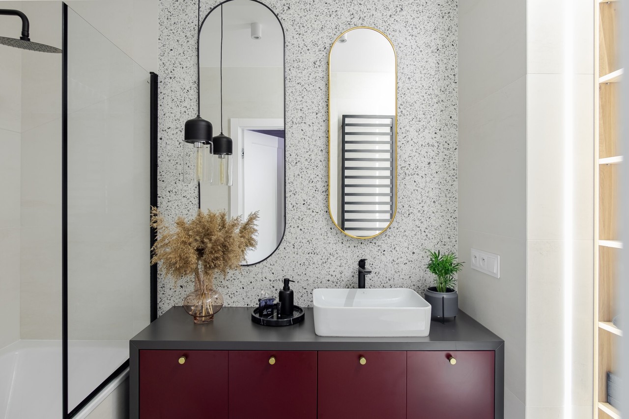 Modern bathroom with minimalist design and mirrors.