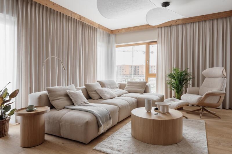 Cosy living room with beige sofa and designer armchair.