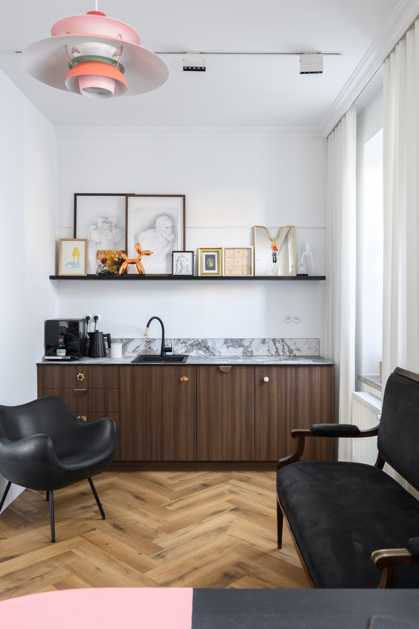 Stylish kitchen with black tap and wooden cabinets.