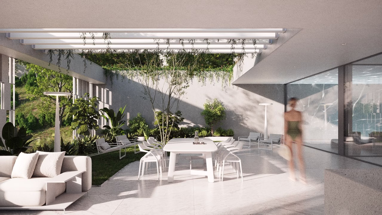 Nowoczesne patio z białymi meblami, zielonymi roślinami, otwarte na ogród.